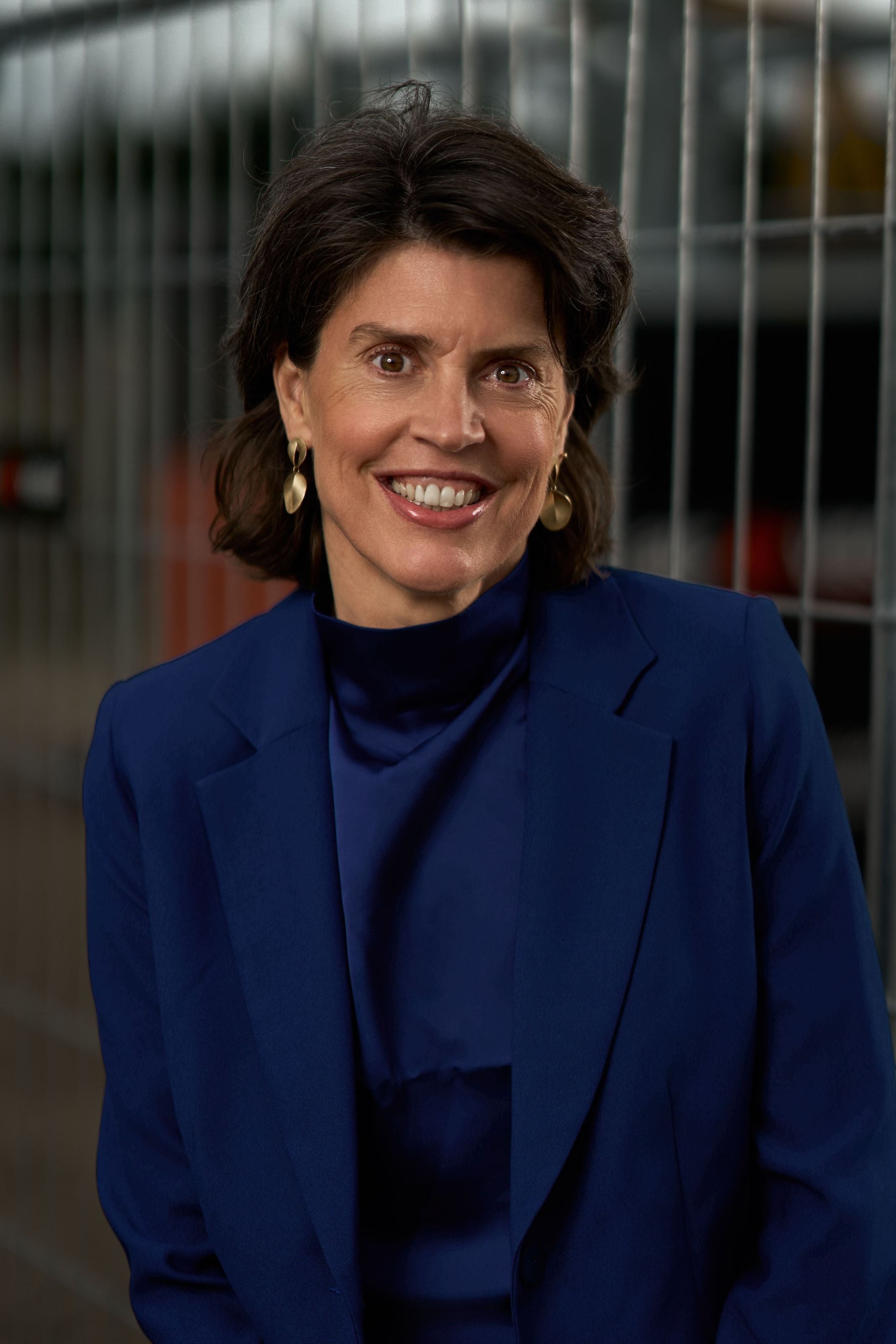 Iris van der Sterre, chief executive of AIC Visser, in a blue blazer in front of a site fence