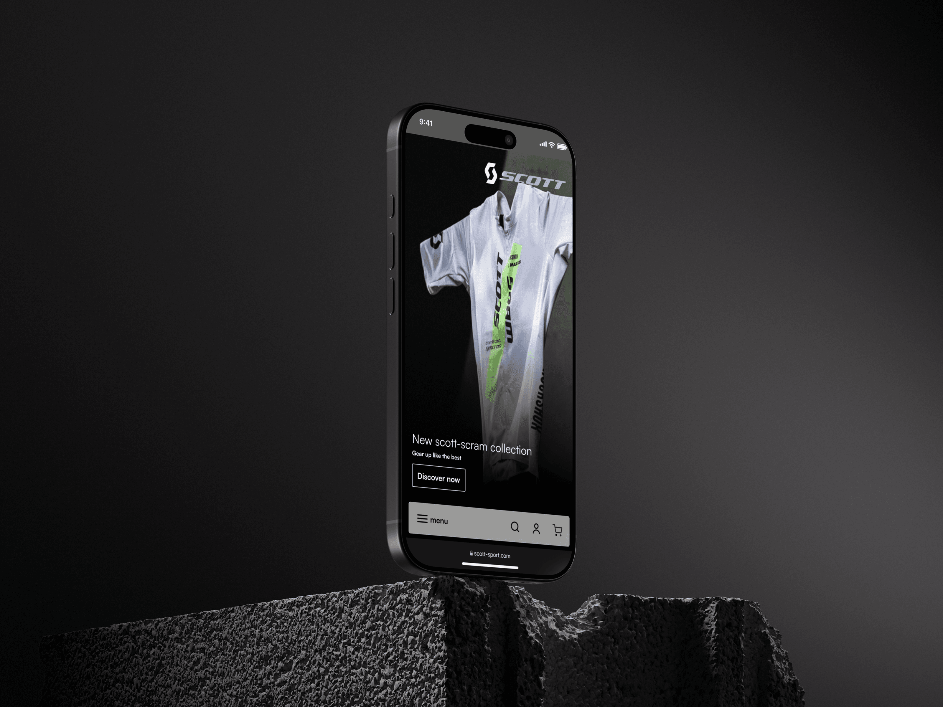 A phone against a dark ground showing a collection hero, a white and green Scott race jersey filling the screen