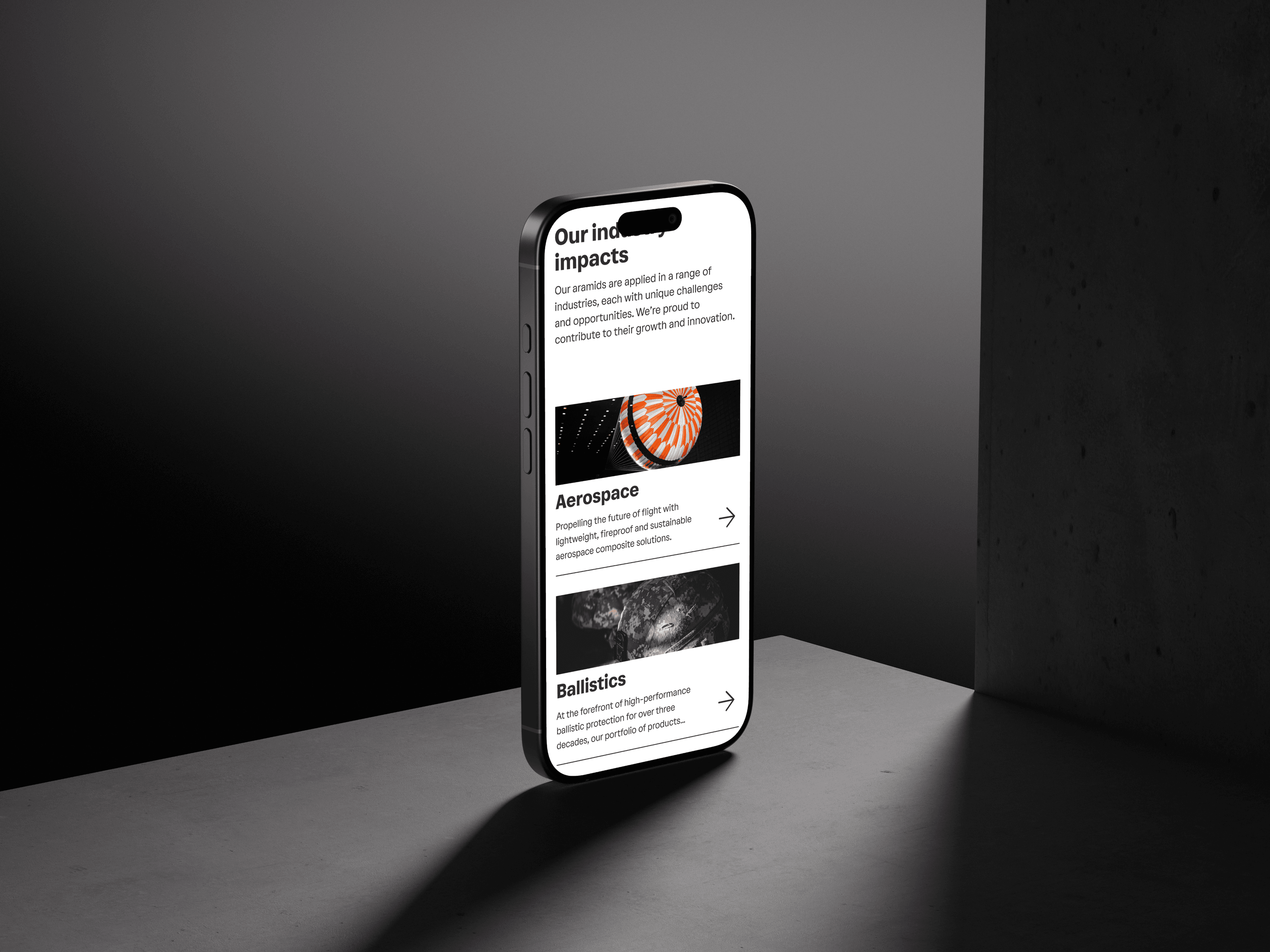 A phone showing the Teijin Aramid site’s industries section, "Our industry impacts" above Aerospace and Ballistics cards